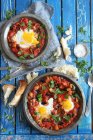 Shakshuka (poached eggs in tomato sauce) with white bread — Stock Photo