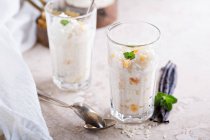 Rice pudding with dried apricots in tall glass — Stock Photo