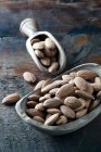 Almonds on a wooden scoop — Stock Photo