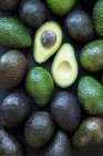 Ripe avocado on a black wooden surface — Stock Photo