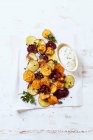 Oven-baked potato, sweet potato and beetroot slices with dip — Stock Photo