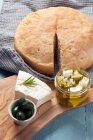 Feta cheese marinated in olive oil and herbs with pita — Stock Photo