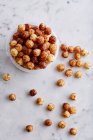 Corn pops in a plastic tub and on a marble background — Stock Photo