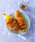 Chocolate croissants with butter and passion fruit jam — Stock Photo