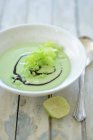 Green pea soup with cream and lemon — Stock Photo