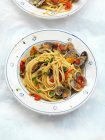Spaghetti pasta with mussels, tomatoes and greens — Stock Photo