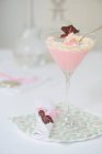 Pink cream dessert with whipped cream in cocktail glass — Stock Photo