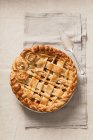Apple pie decorated with dough lattice and dough flowers — Stock Photo