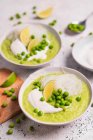 Cream soup with zucchini, green peas and rice noodles — Stock Photo
