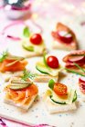 Various canapes with smoked salmon, cheese and salami for Christmas — Stock Photo