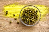 Pickled green peppercorns in a glass bowl — Stock Photo