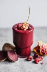 Beetroot smoothie with raspberries pomegranate and currants — Stock Photo