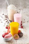 Exotic fruit slush, a strawberry milkshake and a coffee milkshake — Stock Photo
