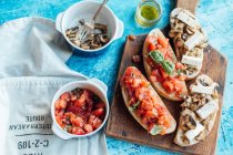 White chiabatta bread cut with toppings, tomato and mushrooms with brie cheese — Stock Photo