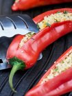 Red peppers stuffed with bulgur wheat and herbs on a grill — Stock Photo