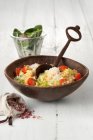 Red lentil risotto with cherry tomatoes, parmesan, and spinach salad — Stock Photo