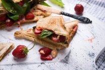 Vegan toasted sandwiches with strawberries, basil and vegan cheese — Stock Photo