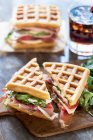 Waffle sandwich with ham, tomato, mozzarella and rocket — Stock Photo