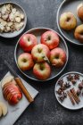Fresh apples and cinnamon sticks on a dark background. top view. — Stock Photo