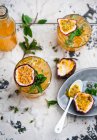 Passion fruit cocktails with ice cubes mint — Stock Photo