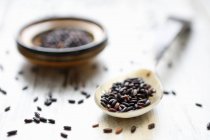 Black rice on a spoon and in a small bowl — Stock Photo