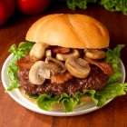 Hamburger with mushrooms, bacon, lettuce — Stock Photo