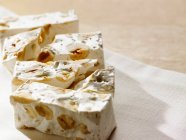 Close-up shot of delicious Pieces of nougat on a napkin — Stock Photo