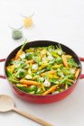 Summer vegetarian paella with carrots, Brussels sprouts and mange tout — Stock Photo