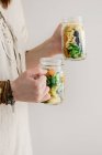 Eine Frau im Leinenkleid mit zwei Salatgläsern — Stockfoto
