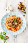 Penne with aubergines and greens served in plate — Stock Photo