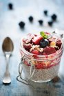 Chia pudding with muesli and berries in a flip-top jar — Stock Photo