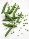 Green peas on a white background — Stock Photo