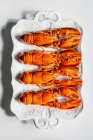 Fresh baked carrots with spices and herbs on white background — Stock Photo