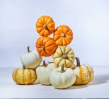 A stack of pie pumpkins balanced in a big tower - fall fun — Stock Photo