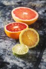 Assorted citrus fruit, halved — Stock Photo