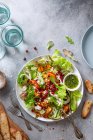 Summer salad with grilled nectarines, mozzarella cheese, pine nuts, cucumber, pomegranate seeds and basil oil — Stock Photo