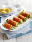 Smoked salmon rolls with cream cheese and rocket — Stock Photo