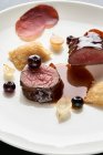 Saddle of venison with potato turnovers and blueberries — Stock Photo