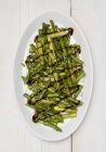 Fried green asparagus with aceto-balsamico cream — Stock Photo