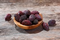Dried cranberries on wooden background — Stock Photo
