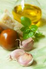 Garlic, tomatoes, Parmesan cheese, basil and olive oil — Stock Photo