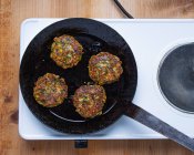 Frying zucchini and leek fritters in a pan — Stock Photo