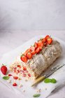 Meringue roulade with fresh whipped cream and strawberries — Stock Photo