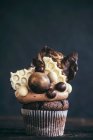 A chocolate cupcake with sweets on the top for a party — Stock Photo