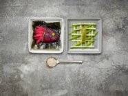 Імбир і копчений лосось, забарвлений буряковим соком, листям норі та огірковими паличками — стокове фото
