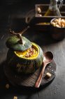 Pumpkin soup with bacon and seeds served in a green pumpkin — Stock Photo