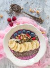 Berry smoothie bowl with bananas, chia, almonds and pumpkin seeds — Stock Photo
