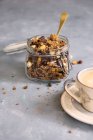 Granola with chocolate in a glass jar — Stock Photo
