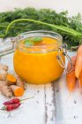 Carrot soup with turmeric, ginger and chili in a flip-top jar — Stock Photo