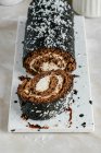 Chocolate roll with vanilla coconut cream — Stock Photo